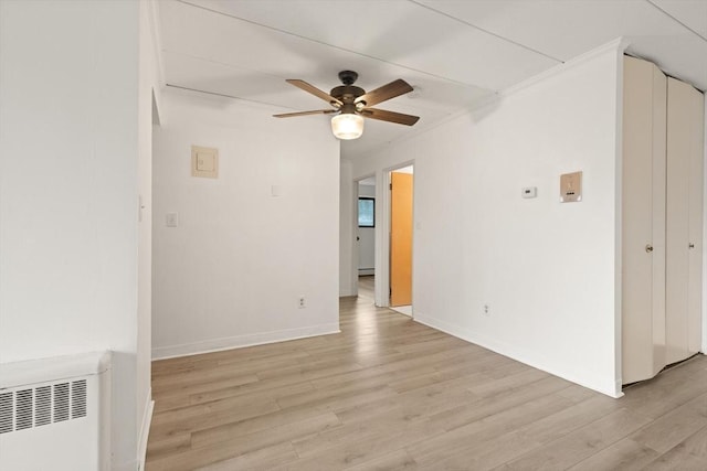 995 Massachusetts Ave Unit 301, Arlington, MA 02476 - unfurnished room with light wood finished floors, ceiling fan, and radiator
