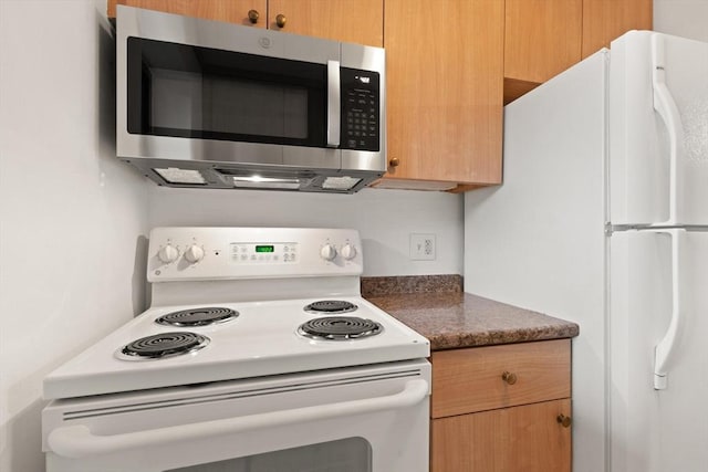 995 Massachusetts Ave Unit 301, Arlington, MA 02476 - kitchen featuring white appliances and dark countertops
