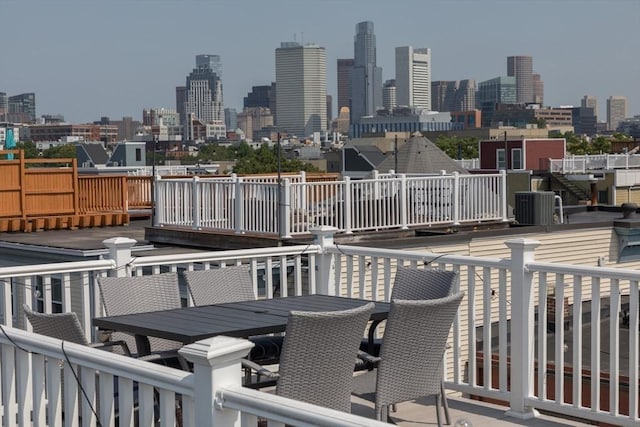 130 Tudor St Unit D, Boston, MA 02127 - wooden deck featuring outdoor dining space and a skyline view