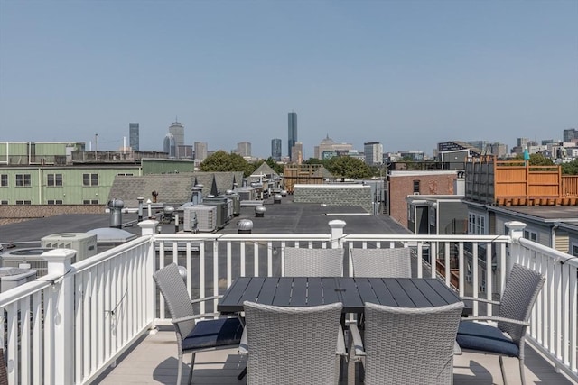 130 Tudor St Unit D, Boston, MA 02127 - wooden deck with a skyline view and outdoor dining space