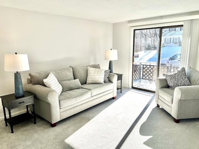 living room featuring carpet floors and baseboards