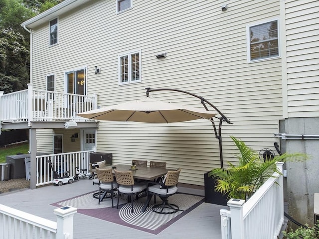 wooden terrace with outdoor dining space