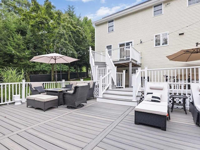 wooden deck with stairway and an outdoor hangout area