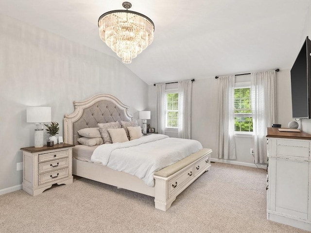 bedroom with baseboards, light colored carpet, and a chandelier