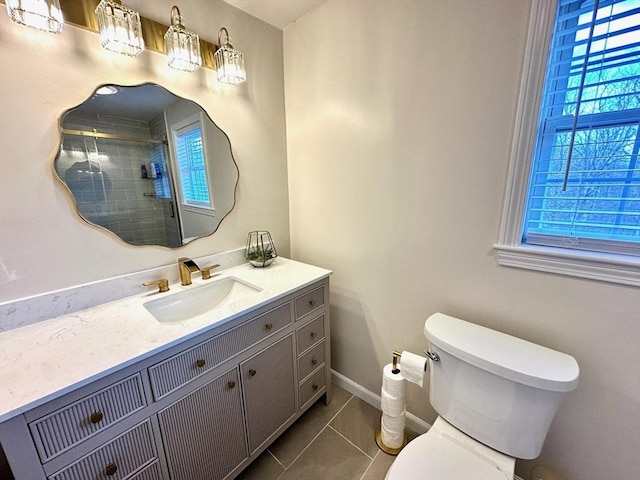 full bathroom with vanity, baseboards, a tile shower, tile patterned floors, and toilet