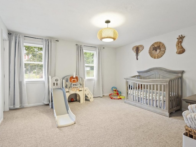 bedroom with carpet flooring, multiple windows, and baseboards