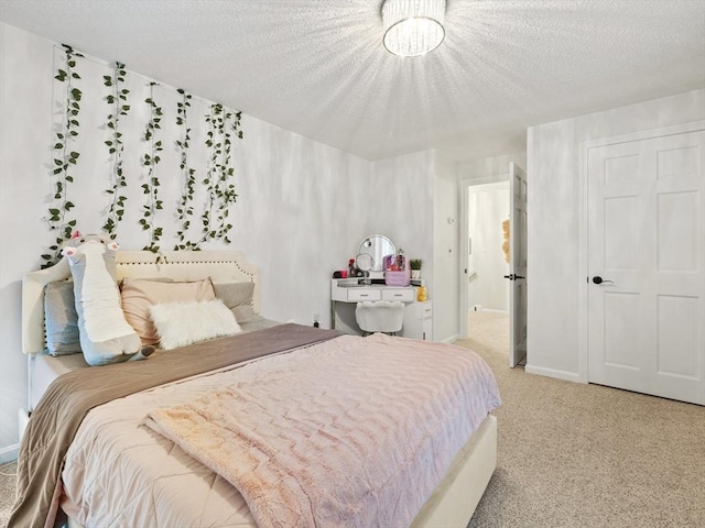 bedroom with baseboards, a textured ceiling, and carpet