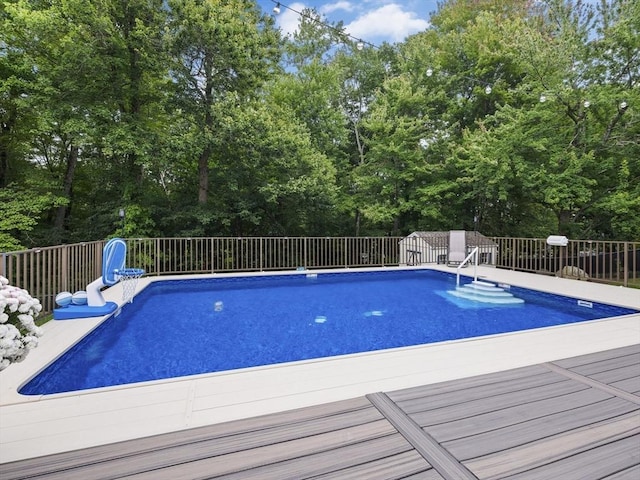 view of pool with a deck and a fenced in pool