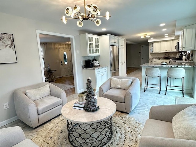 living area featuring recessed lighting and baseboards