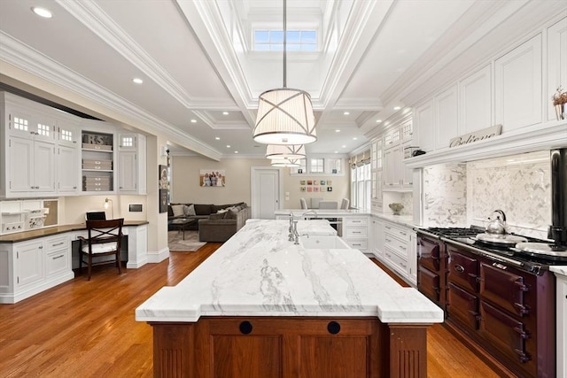 4 Cobb Ave, Manchester, MA 01944 - kitchen with light wood finished floors, white cabinets, a kitchen island with sink, open floor plan, and recessed lighting