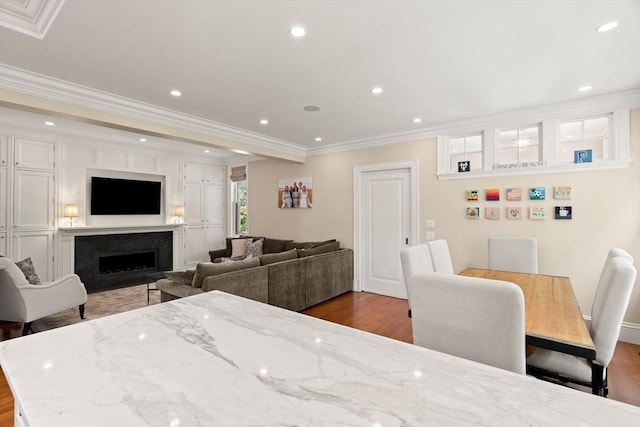 4 Cobb Ave, Manchester, MA 01944 - dining room featuring wood finished floors, crown molding, a fireplace, and recessed lighting