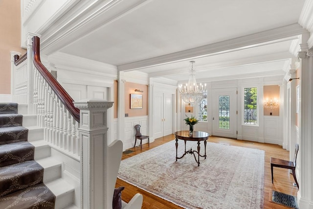 4 Cobb Ave, Manchester, MA 01944 - foyer featuring a decorative wall, crown molding, stairs, a chandelier, and a wainscoted wall