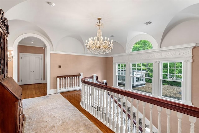 4 Cobb Ave, Manchester, MA 01944 - corridor with a chandelier, an upstairs landing, wood finished floors, arched walkways, and vaulted ceiling