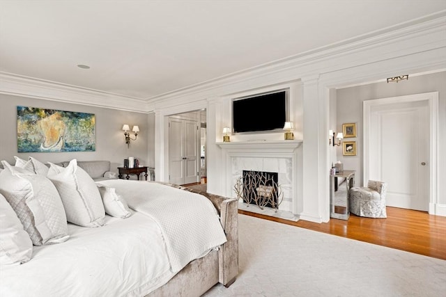 4 Cobb Ave, Manchester, MA 01944 - bedroom featuring a tiled fireplace, ornamental molding, and wood finished floors