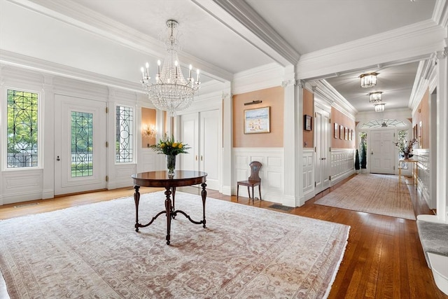 4 Cobb Ave, Manchester, MA 01944 - entryway with a decorative wall, hardwood / wood-style floors, a chandelier, and crown molding