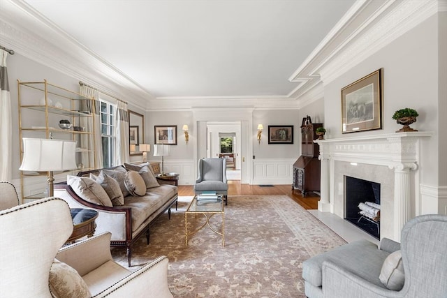 4 Cobb Ave, Manchester, MA 01944 - living room with ornamental molding, a fireplace, wood finished floors, a wainscoted wall, and a decorative wall