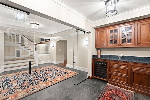 4 Cobb Ave, Manchester, MA 01944 - bar area featuring beverage cooler, arched walkways, crown molding, stairway, and dark tile patterned flooring