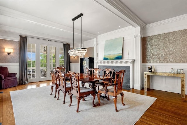 4 Cobb Ave, Manchester, MA 01944 - dining room featuring wallpapered walls, ornamental molding, a wainscoted wall, wood finished floors, and a chandelier