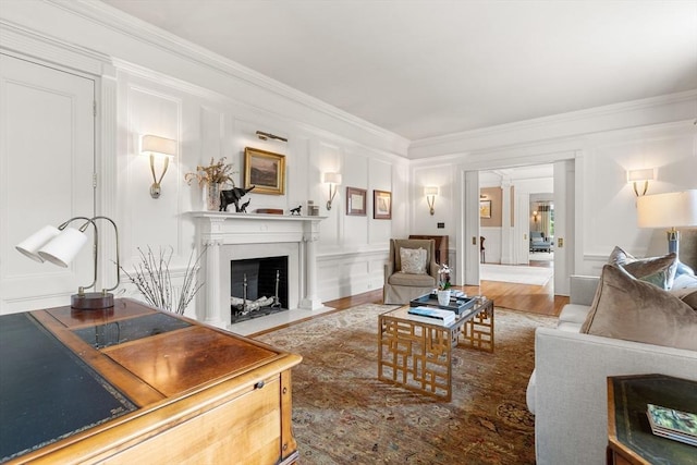 4 Cobb Ave, Manchester, MA 01944 - living room with ornamental molding, a decorative wall, a fireplace with flush hearth, and wood finished floors