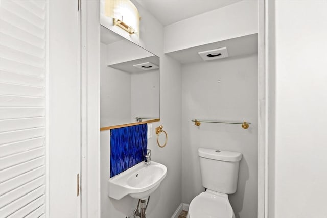 half bath featuring toilet