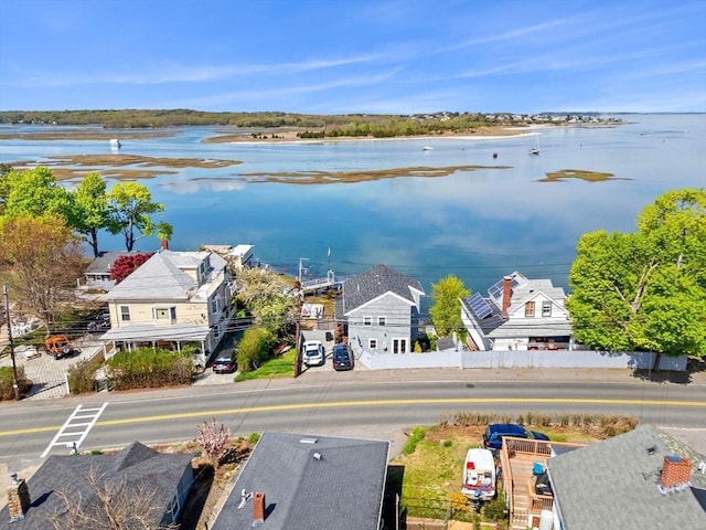 aerial view of residential area featuring a nearby body of water