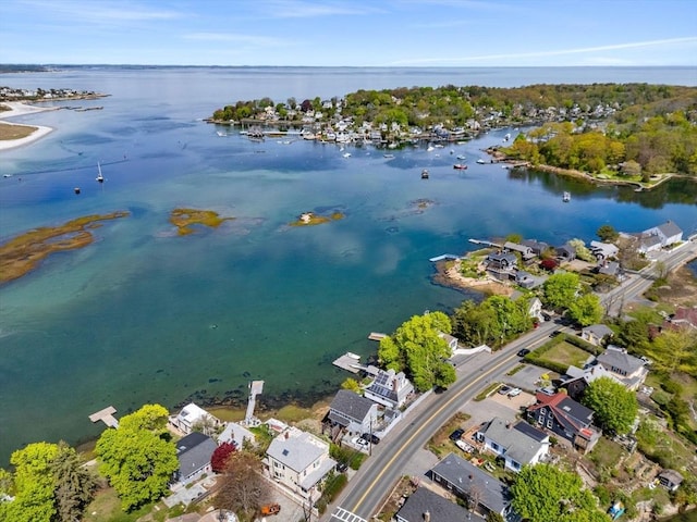 aerial view of property's location with a large body of water and nearby suburban area