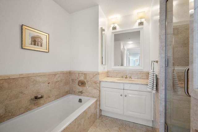 bathroom with tile patterned flooring, vanity, and shower with separate bathtub