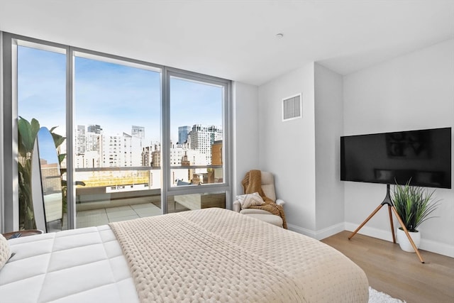 bedroom featuring light hardwood / wood-style floors and multiple windows