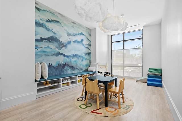 dining room with floor to ceiling windows and hardwood / wood-style flooring