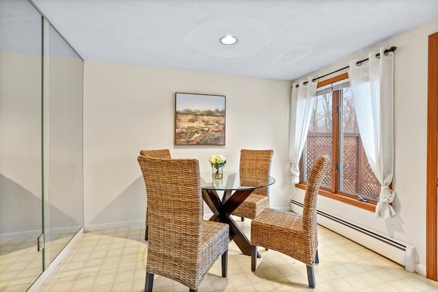 dining space featuring a baseboard heating unit