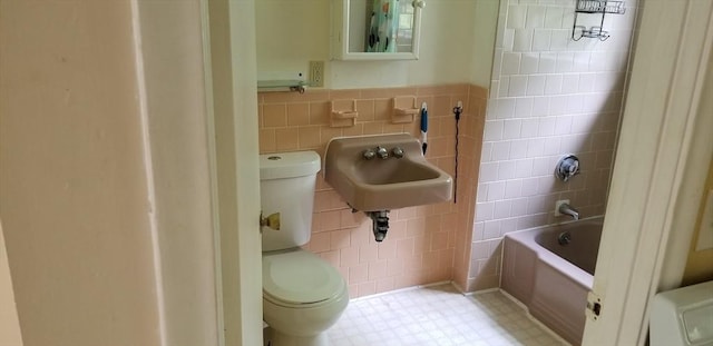 full bathroom featuring tile walls, sink, shower / washtub combination, and toilet