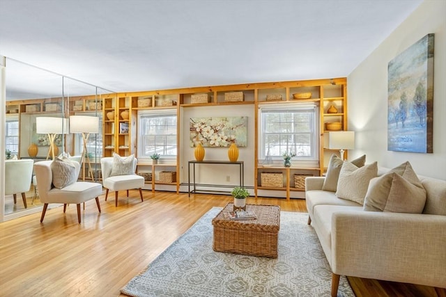 sitting room with a wealth of natural light and hardwood / wood-style floors