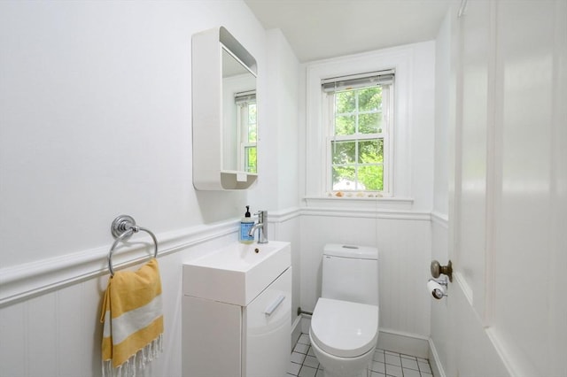 51 Rustlewood Rd, Milton, MA 02186 - half bath featuring toilet, a wainscoted wall, tile patterned floors, vanity, and a decorative wall