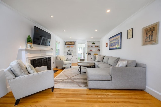 51 Rustlewood Rd, Milton, MA 02186 - living room featuring ornamental molding, a fireplace with flush hearth, light wood finished floors, recessed lighting, and built in features