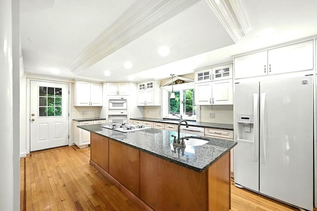 1095 Main St, Hanover, MA 02339 - kitchen with white appliances, a kitchen island with sink, light wood-type flooring, white cabinetry, and recessed lighting