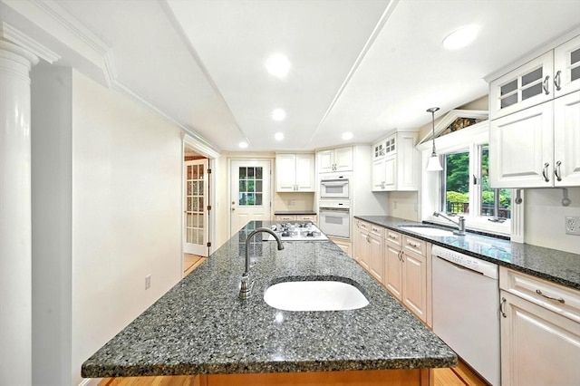 1095 Main St, Hanover, MA 02339 - kitchen featuring white appliances, recessed lighting, a center island with sink, dark stone counters, and glass insert cabinets