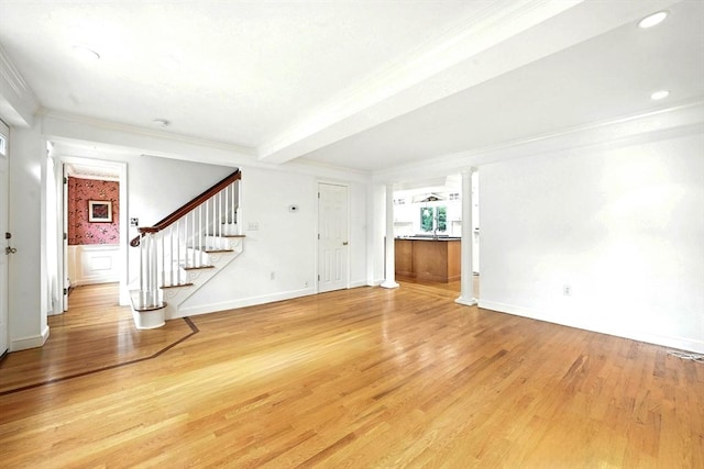 1095 Main St, Hanover, MA 02339 - unfurnished living room featuring ornamental molding, stairway, light wood-type flooring, and beamed ceiling