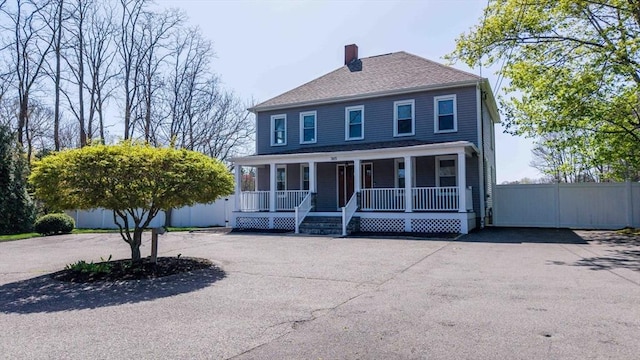 365 Middle Rd, Acushnet, MA 02743 - colonial house with a porch, a shingled roof, fence, and a chimney