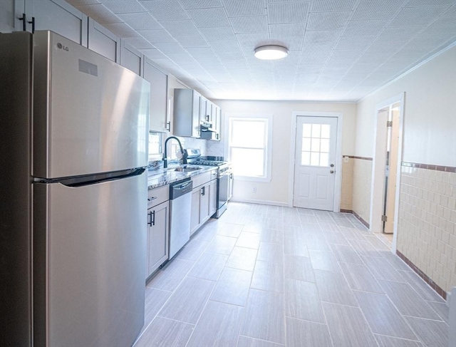 73 Sladen St, Dracut, MA 01826 - kitchen with stainless steel appliances, light stone counters, and a wainscoted wall