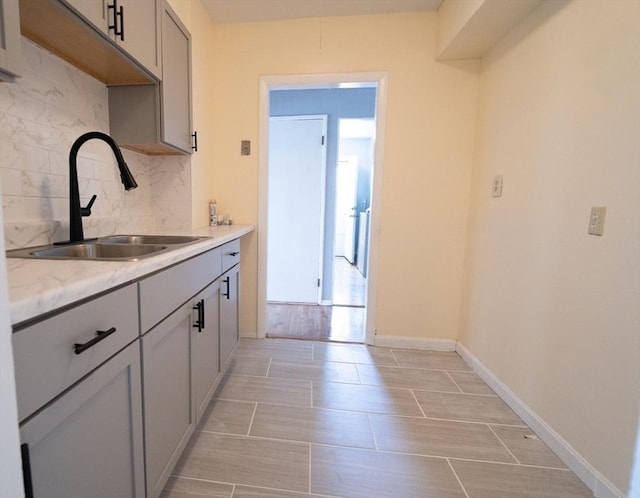 73 Sladen St, Dracut, MA 01826 - kitchen featuring backsplash, gray cabinets, and light stone counters