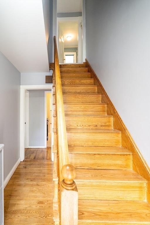 73 Sladen St, Dracut, MA 01826 - staircase featuring wood finished floors and baseboards