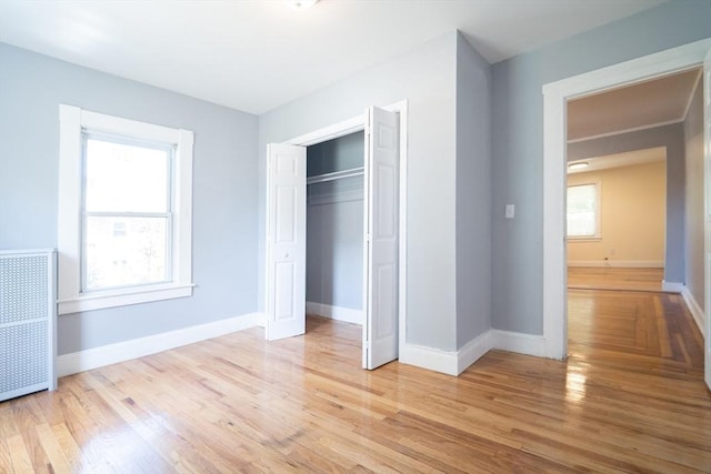 73 Sladen St, Dracut, MA 01826 - unfurnished bedroom with radiator, light wood-style floors, and a closet