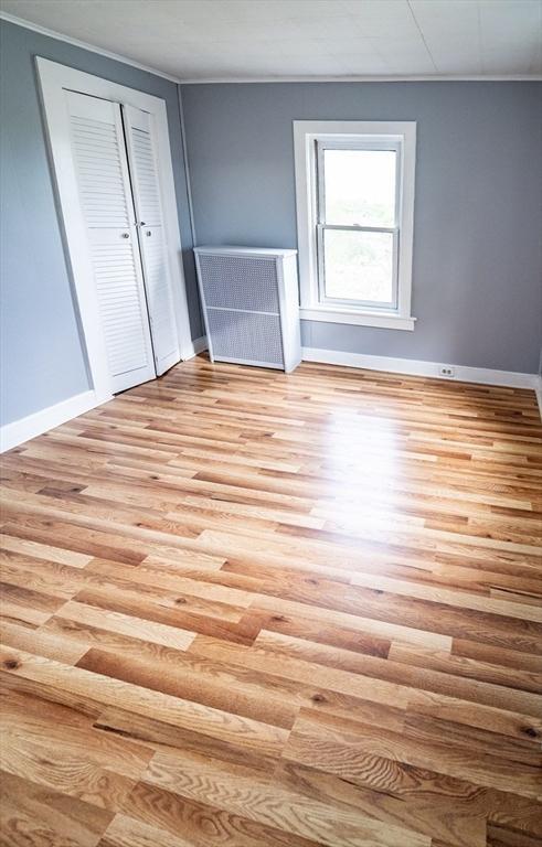 73 Sladen St, Dracut, MA 01826 - unfurnished bedroom featuring wood finished floors and a closet