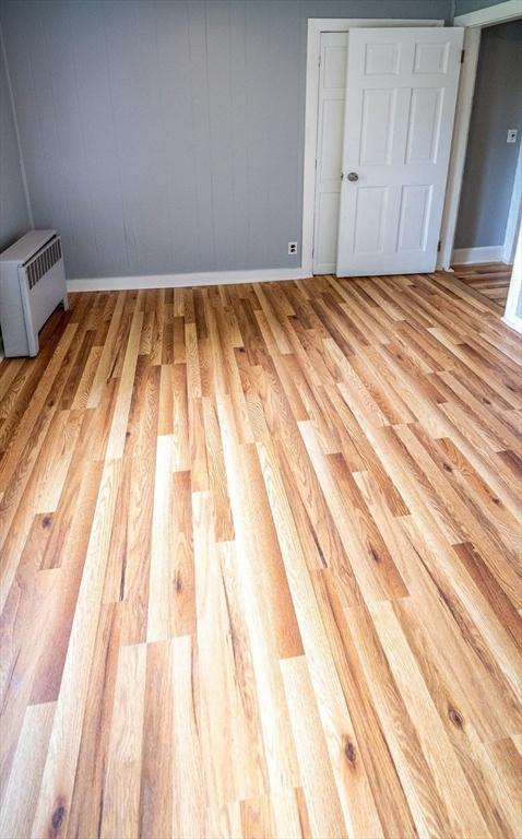 73 Sladen St, Dracut, MA 01826 - unfurnished bedroom with light wood finished floors and a closet