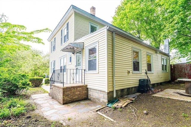 73 Sladen St, Dracut, MA 01826 - back of property featuring a chimney