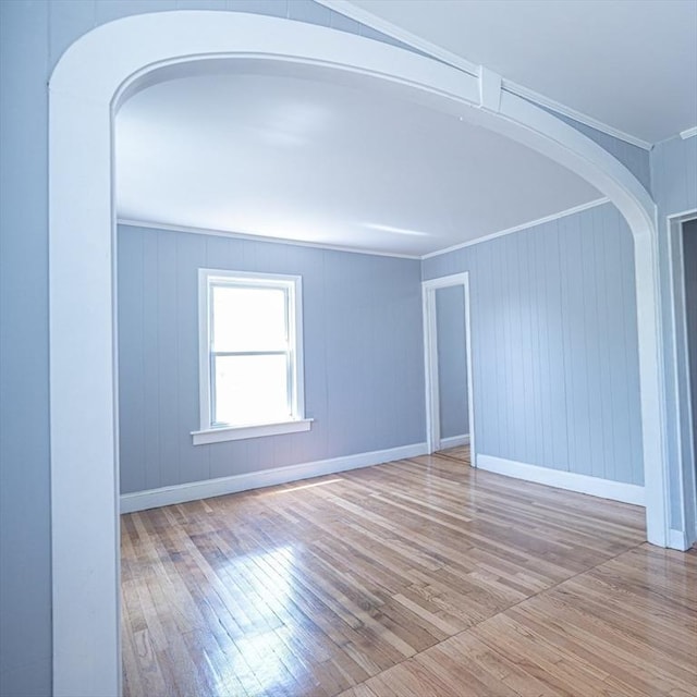 73 Sladen St, Dracut, MA 01826 - spare room with arched walkways, wood-type flooring, and ornamental molding