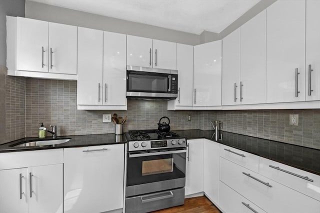 14 Linden St Unit 8, Brookline, MA 02445 - kitchen featuring stainless steel appliances, white cabinets, dark countertops, and dark wood-type flooring