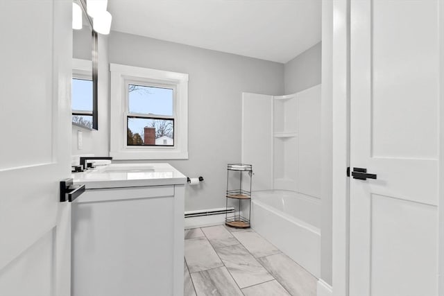 bathroom featuring baseboard heating, shower / tub combination, and vanity