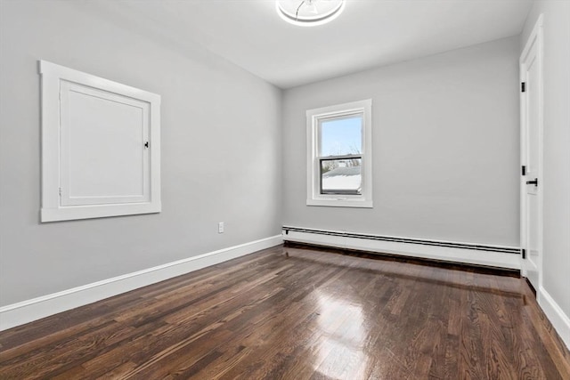 unfurnished room with dark wood-type flooring and a baseboard heating unit