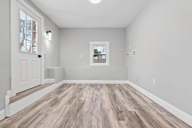 foyer entrance with light hardwood / wood-style floors and a wealth of natural light